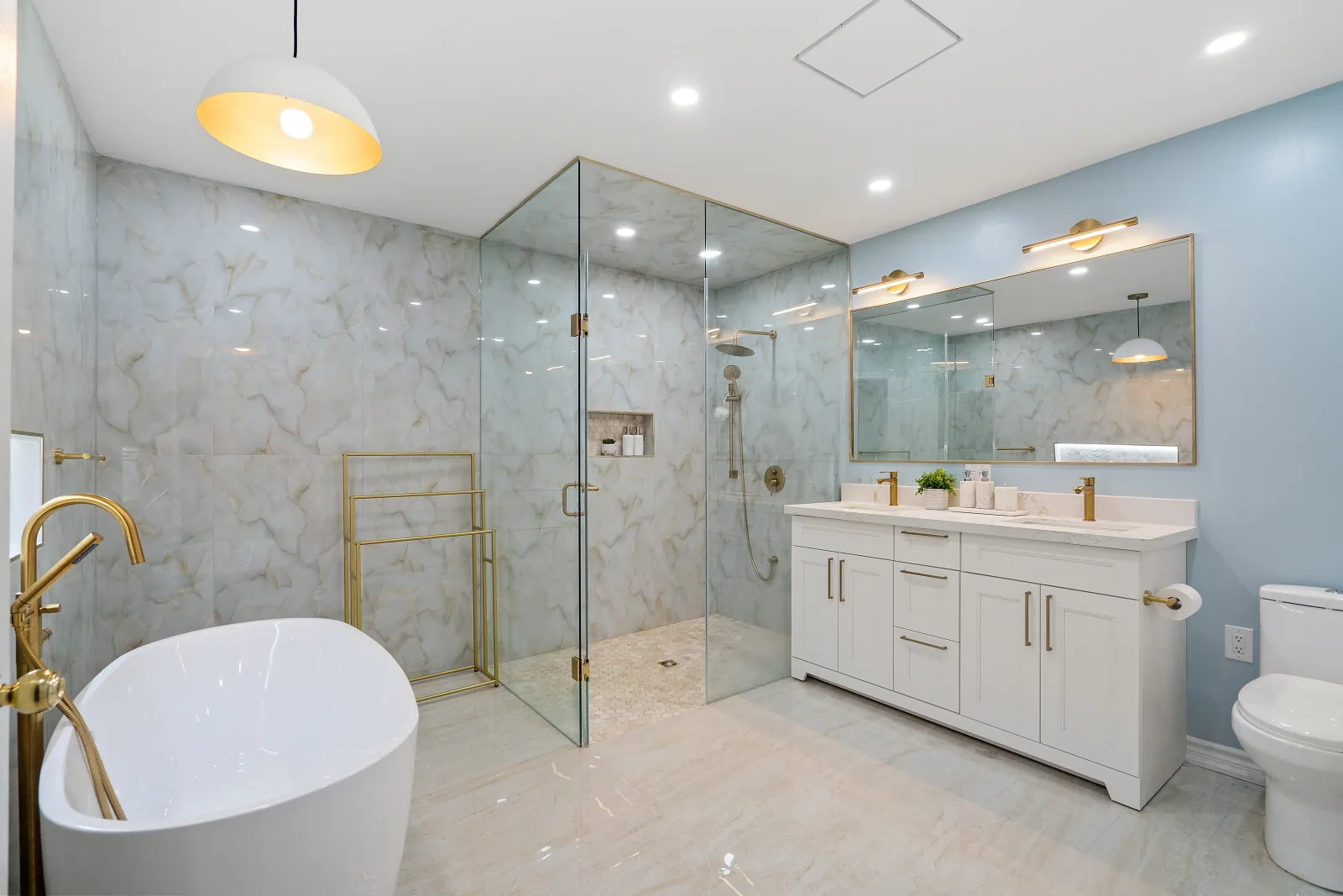Primary ensuite with a freestanding tub, glass corner shower and double vanity